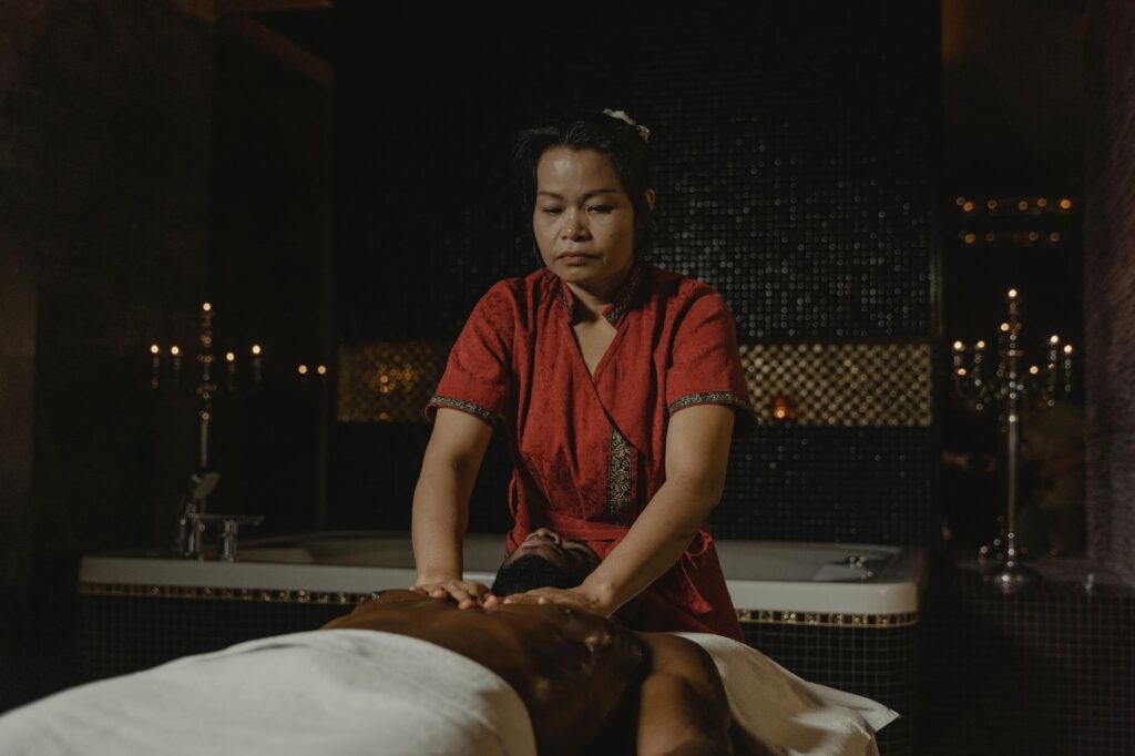 Spa treatment room with candles and calming natural light